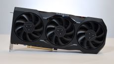 An AMD Radeon RX 7900 XTX on a table against a white backdrop